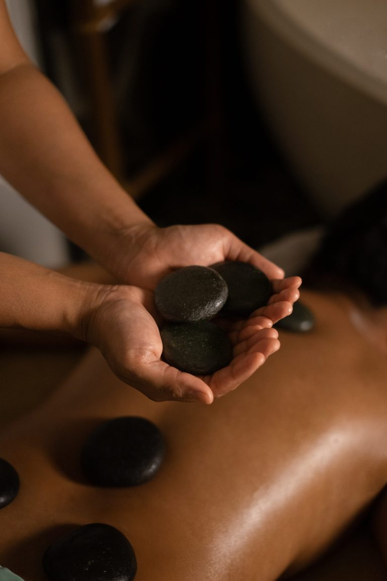Therapist holding warm basalt stones